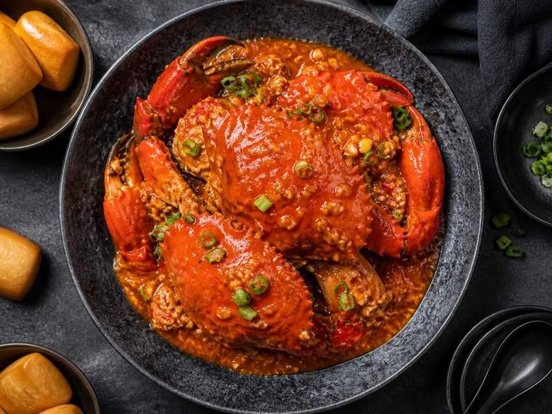 Crab in a glossy red chilli sauce with fried buns