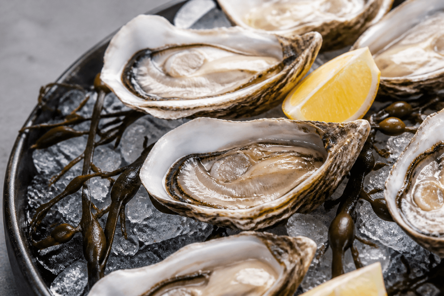 Fresh oysters on ice with lemon wedges and sea salt