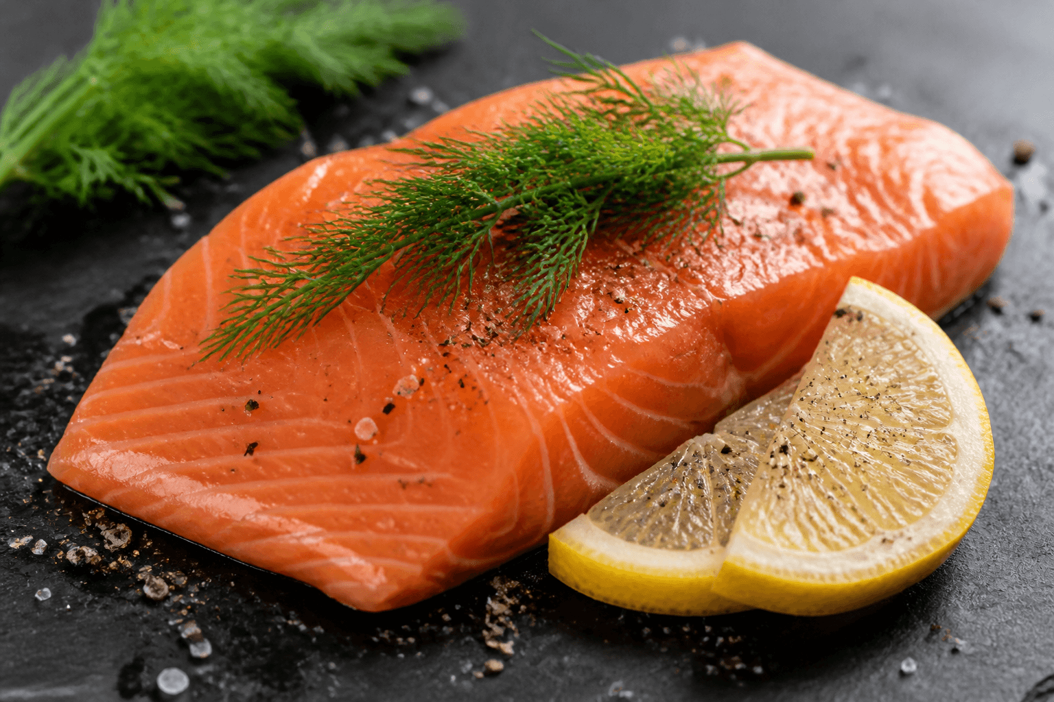 Fresh salmon fillet with lemon, dill, and cracked pepper
