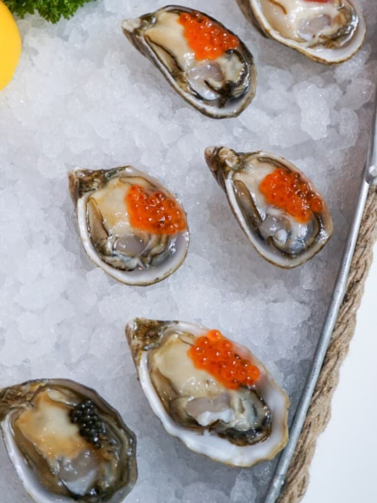 Oysters with salmon roe on ice